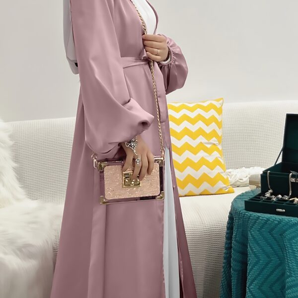 Model wearing Newness's Serene Sands Satin Abaya, a flowing maxi dress in luxurious satin fabric. The abaya is elegantly styled and perfect for any occasion.