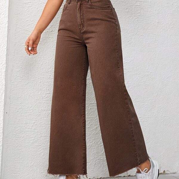 Newness Effortless Chic Wide Leg Jeans: Flattering wide-leg jeans in a versatile wash, perfect for any occasion. Model showcases effortless style.