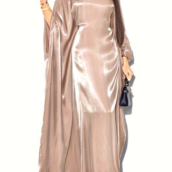 Model wearing Newness's Celestial Shimmer Metallic Abaya, a flowing maxi dress with a metallic shimmer, perfect for any occasion.