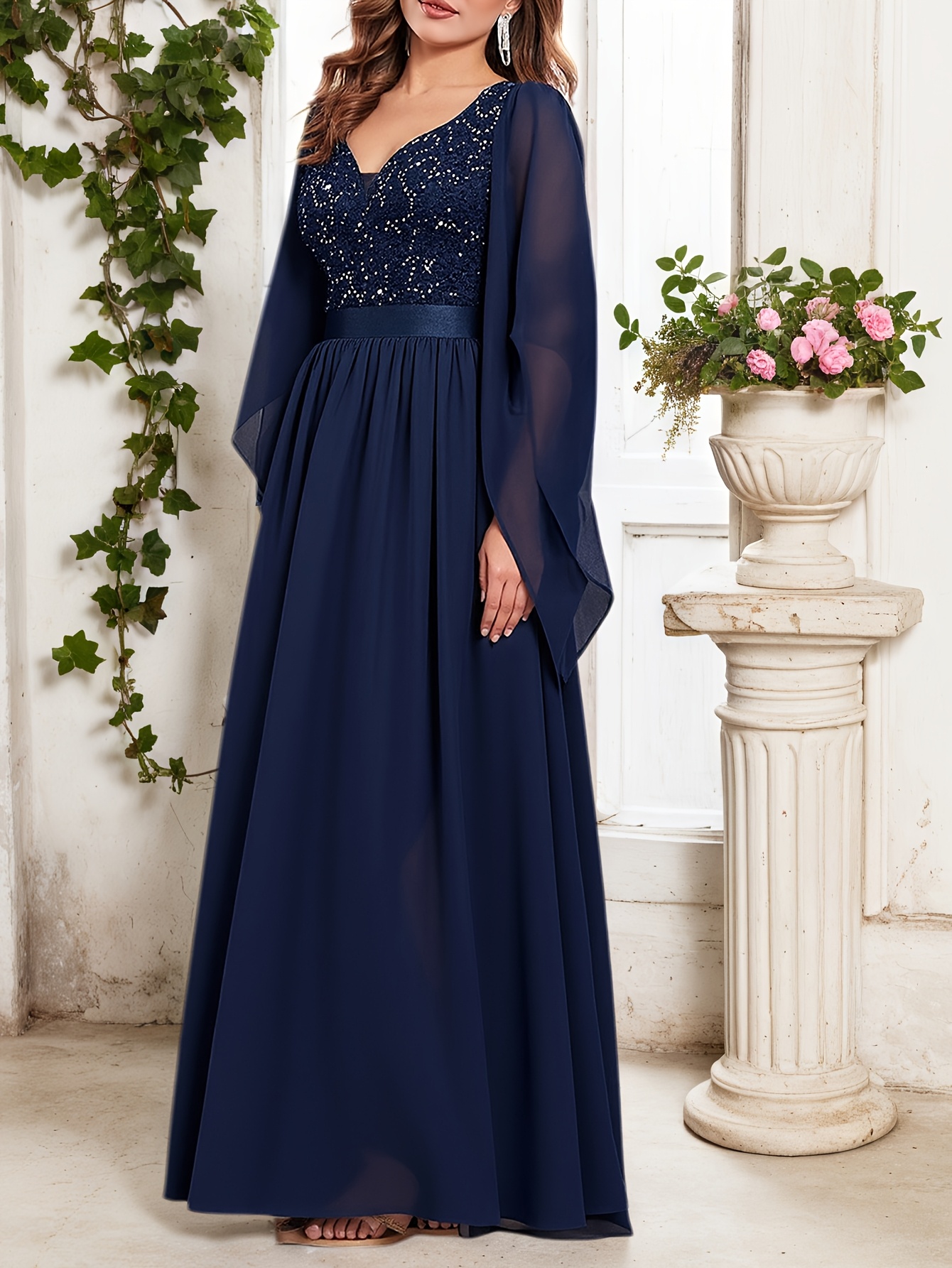Model wearing a stunning Celestial Nights sequin midi dress, perfect for weddings and formal events. The dress shimmers under the light, showcasing its intricate sequin detailing.