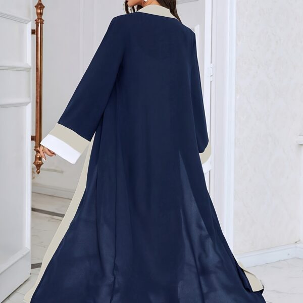 Model wearing the Casablanca Color-Block Abaya Dress, a stylish and modern abaya with colorblocked panels. The dress features a relaxed fit and elegant silhouette.