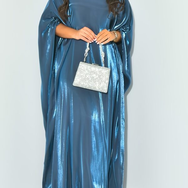 Model wearing Newness's Celestial Shimmer Metallic Abaya, a flowing maxi dress with a metallic shimmer, perfect for any occasion.