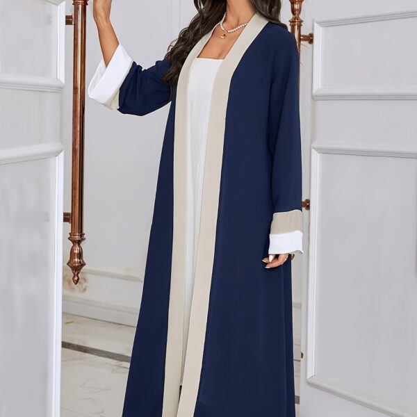 Model wearing the Casablanca Color-Block Abaya Dress, a stylish and modern abaya with colorblocked panels. The dress features a relaxed fit and elegant silhouette.