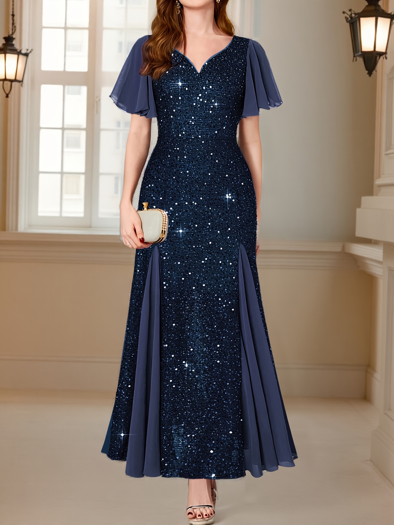 Model wearing a stunning Midnight Bloom sequin evening gown, perfect for a special occasion. The gown shimmers under the lights, showcasing intricate sequin details.