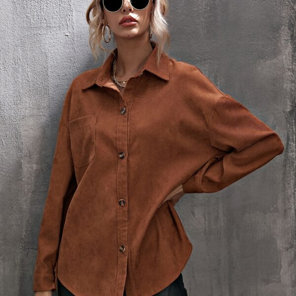 Newness Asymmetrical Hem Corduroy Shirt in deep green, featuring a flattering, asymmetrical hemline and classic corduroy texture. Model wears size small.