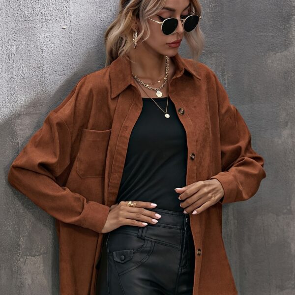 Newness Asymmetrical Hem Corduroy Shirt in deep green, featuring a flattering, asymmetrical hemline and classic corduroy texture. Model wears size small.
