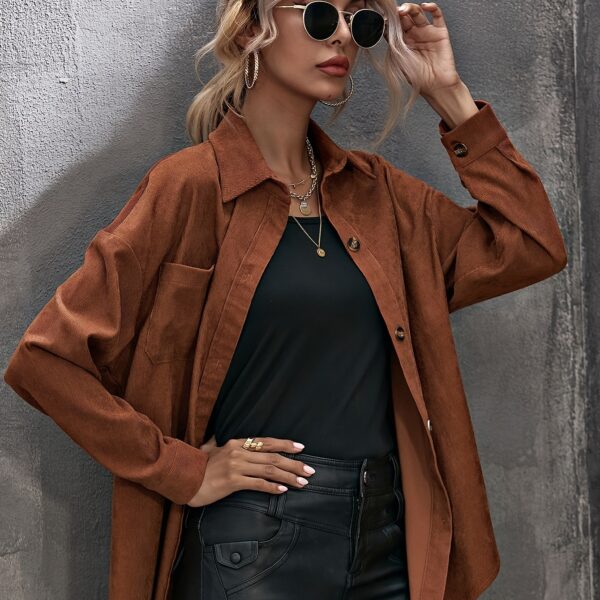 Newness Asymmetrical Hem Corduroy Shirt in deep green, featuring a flattering, asymmetrical hemline and classic corduroy texture. Model wears size small.