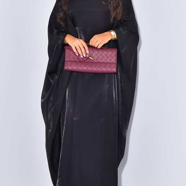 Model wearing Newness's Celestial Shimmer Metallic Abaya, a flowing maxi dress with a metallic shimmer, perfect for any occasion.