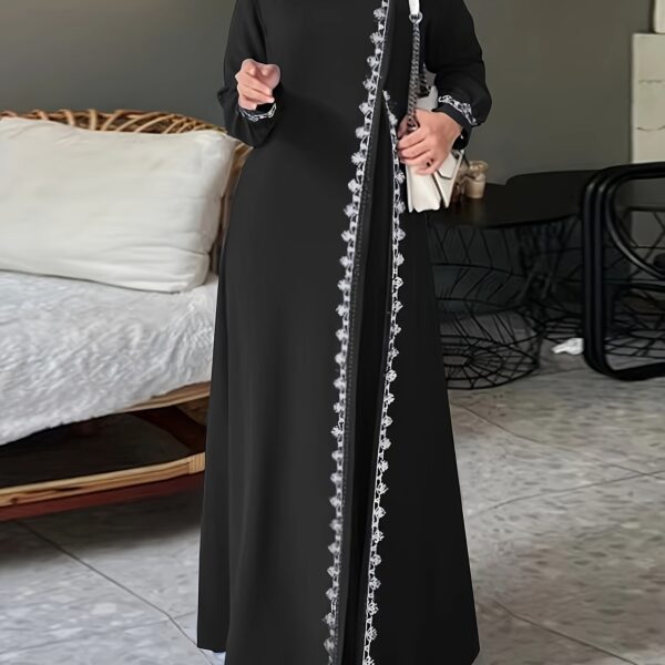 Model wearing the Newness Serene Crochet Maxi Dress, a stunning floor-length crochet dress perfect for any occasion. The dress drapes beautifully, showcasing its intricate crochet detailing.