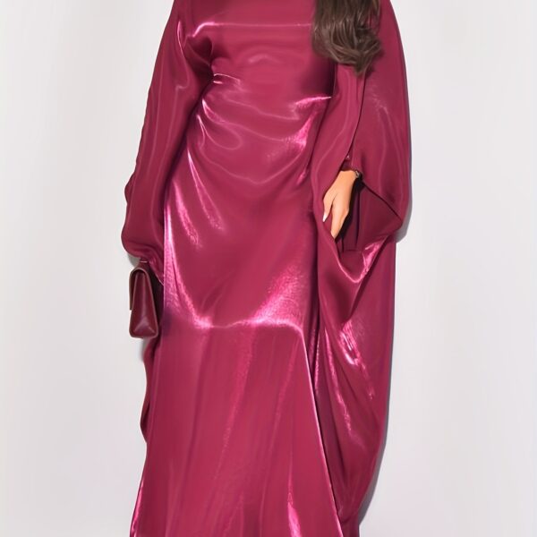 Model wearing Newness's Celestial Shimmer Metallic Abaya, a flowing maxi dress with a metallic shimmer, perfect for any occasion.