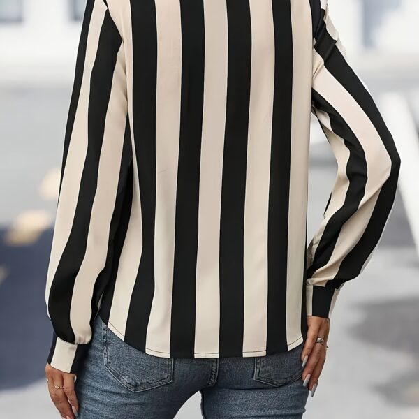 Newness Parisian Striped Blouse: A chic, timeless striped blouse perfect for elevating any outfit. Model showcases the blouse's flattering fit and versatile style.