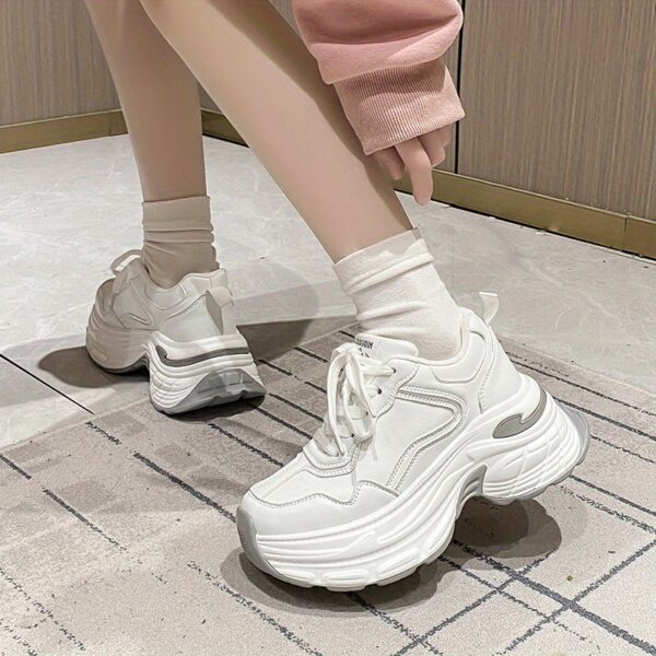 Newness CloudWalk Platform Sneakers in white, showcasing the chunky platform sole and sleek design. Model is walking, demonstrating comfort and style.
