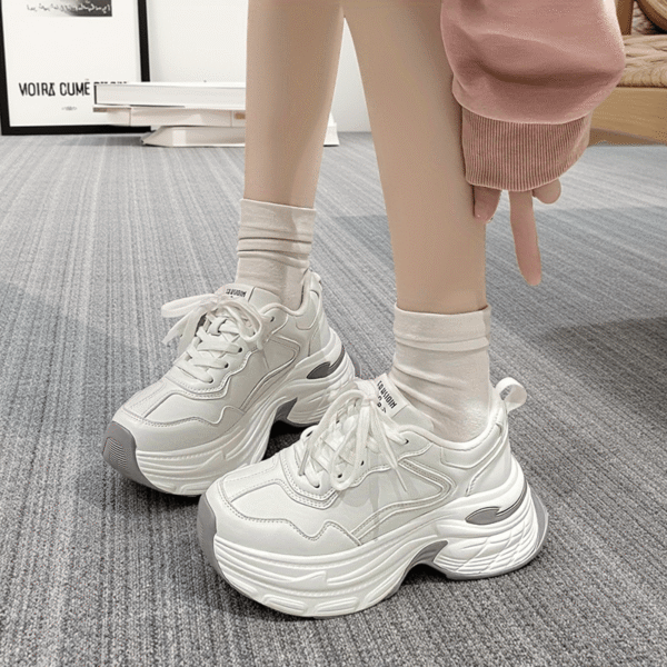 Newness CloudWalk Platform Sneakers in white, showcasing the chunky platform sole and sleek design. Model is walking, demonstrating comfort and style.