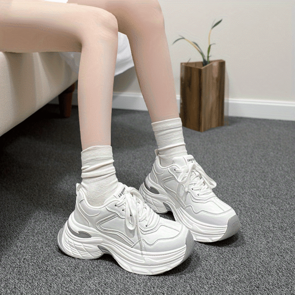 Newness CloudWalk Platform Sneakers in white, showcasing the chunky platform sole and sleek design. Model is walking, demonstrating comfort and style.