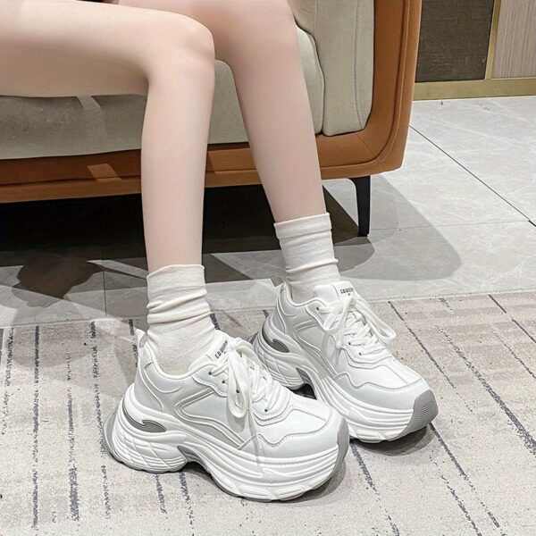 Newness CloudWalk Platform Sneakers in white, showcasing the chunky platform sole and sleek design. Model is walking, demonstrating comfort and style.
