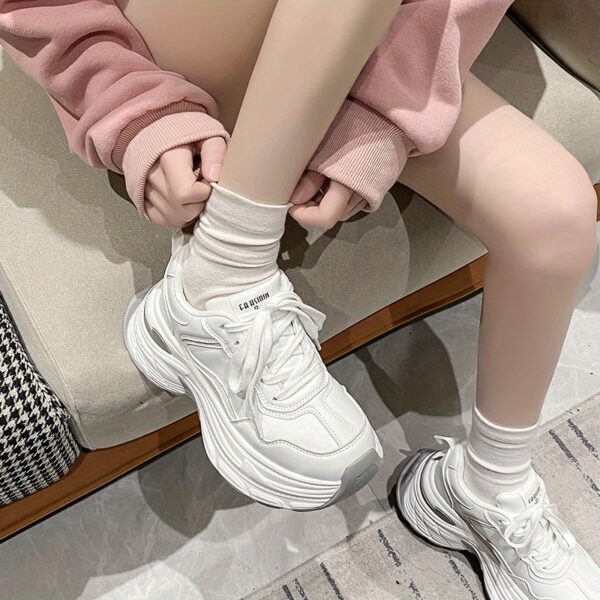 Newness CloudWalk Platform Sneakers in white, showcasing the chunky platform sole and sleek design. Model is walking, demonstrating comfort and style.