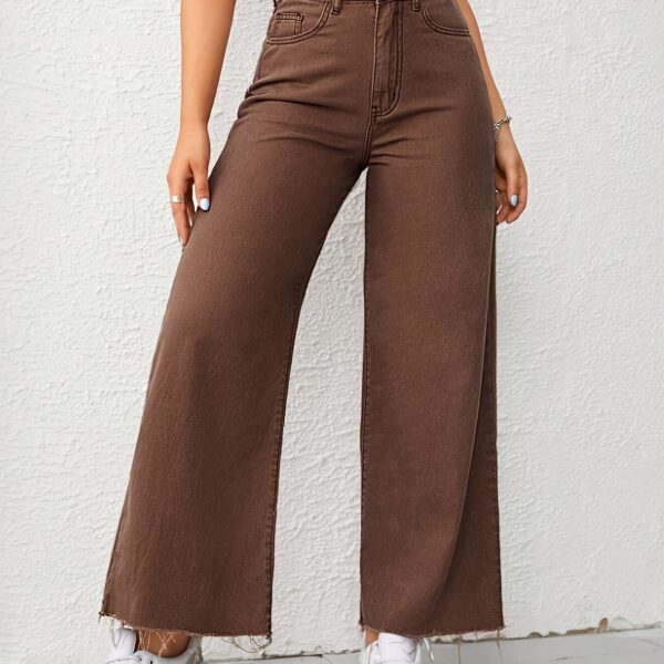 Newness Effortless Chic Wide Leg Jeans: Flattering wide-leg jeans in a versatile wash, perfect for any occasion. Model showcases effortless style.