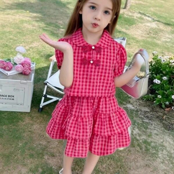 Adorable toddler girl wearing a charming Summer Bloom skirt set, perfect for summer playdates and outdoor fun. The set features a vibrant floral print and comfortable, breathable fabric.