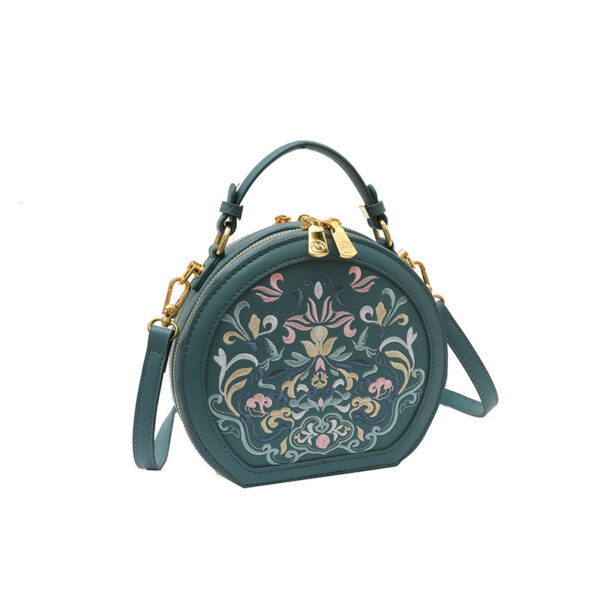 Vienna Embroidered Crossbody Bag in chic faux leather with golden hardware and unique embroidered design.