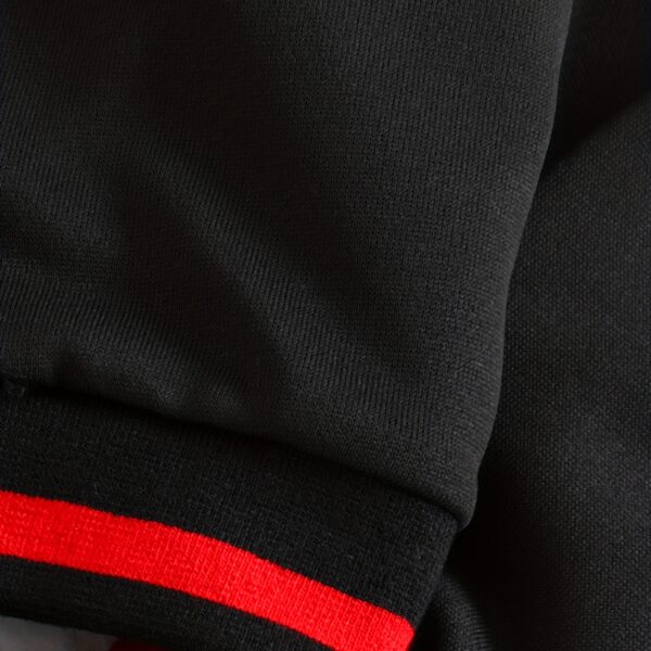 Stylish preppy varsity jacket and skirt set in navy and cream, modeled on a student in a school setting