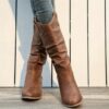 Newness Sunset Rider Ruched Cowboy Boots Brown leather cowboy boots with ruched detailing shown from the side in a lifestyle shot