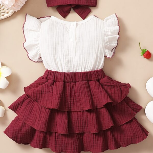 Adorable toddler girl in a vibrant Summer Bloom dress, perfect for summer adventures. The dress features a playful floral print and comfortable, breathable fabric.