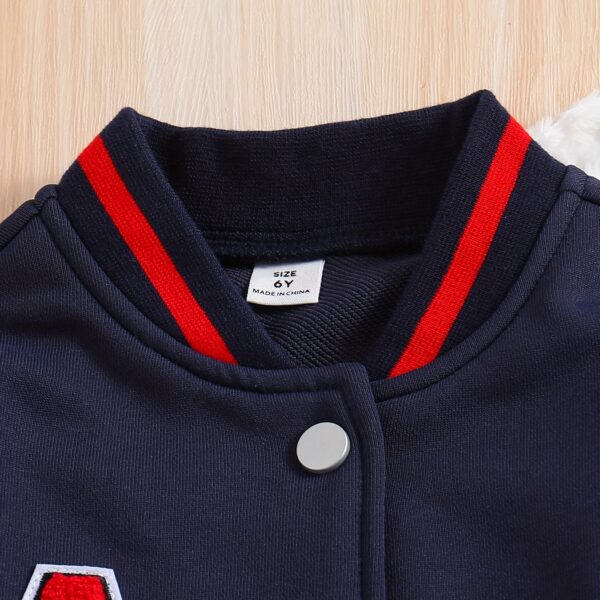 Stylish preppy varsity jacket and skirt set in navy and cream, modeled on a student in a school setting