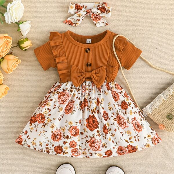 Adorable baby girl wearing a Summer Bloom floral dress, perfect for summer.