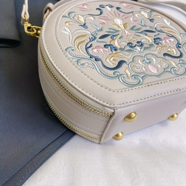 Vienna Embroidered Crossbody Bag in chic faux leather with golden hardware and unique embroidered design.