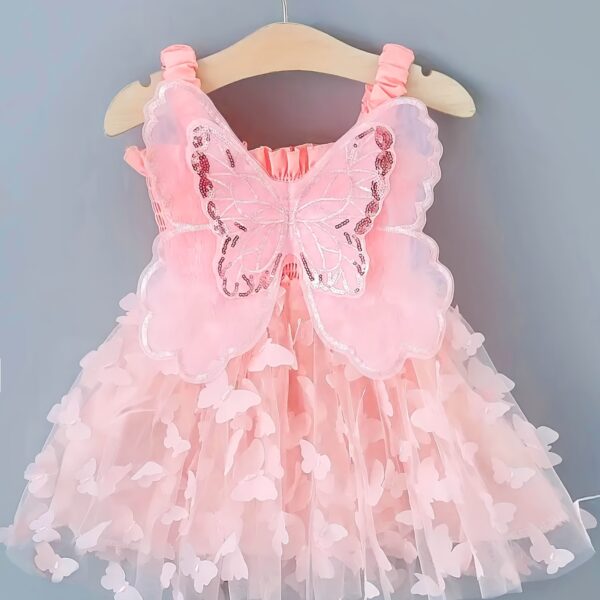 Adorable baby girl wearing a Flutterby Mesh Butterfly Dress, a perfect summer outfit from Newness.