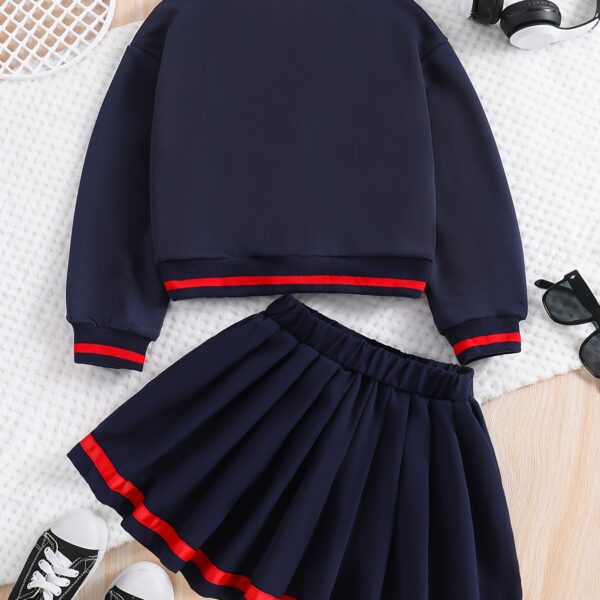Stylish preppy varsity jacket and skirt set in navy and cream, modeled on a student in a school setting