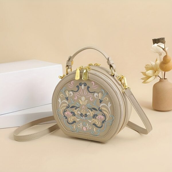Vienna Embroidered Crossbody Bag in chic faux leather with golden hardware and unique embroidered design.