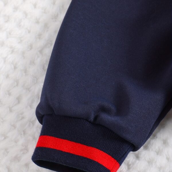 Stylish preppy varsity jacket and skirt set in navy and cream, modeled on a student in a school setting
