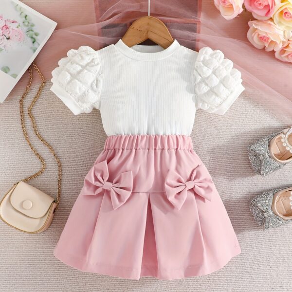 Adorable Pastel Dream Girls' Summer Set featuring a pastel-colored top and bottom, perfect for summer. The outfit is shown on a young girl, highlighting its comfortable and stylish design.