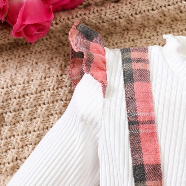 Adorable girl wearing a red and white plaid dress and matching beret. Perfect for spring or fall.
