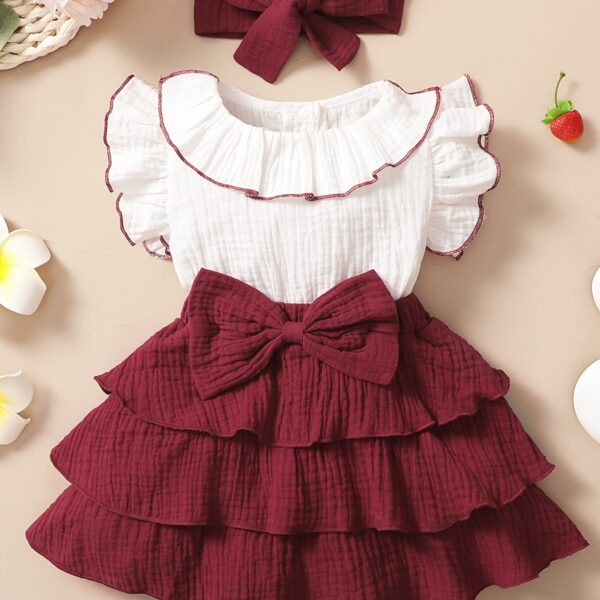 Adorable toddler girl in a vibrant Summer Bloom dress, perfect for summer adventures. The dress features a playful floral print and comfortable, breathable fabric.