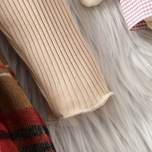 Adorable girl wearing a red and white plaid dress and matching beret. Perfect for spring or fall.