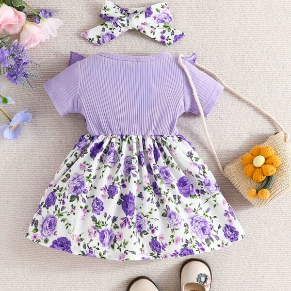 Adorable baby girl wearing a Summer Bloom floral dress, perfect for summer.