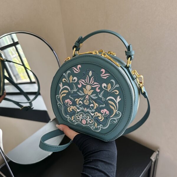 Vienna Embroidered Crossbody Bag in chic faux leather with golden hardware and unique embroidered design.
