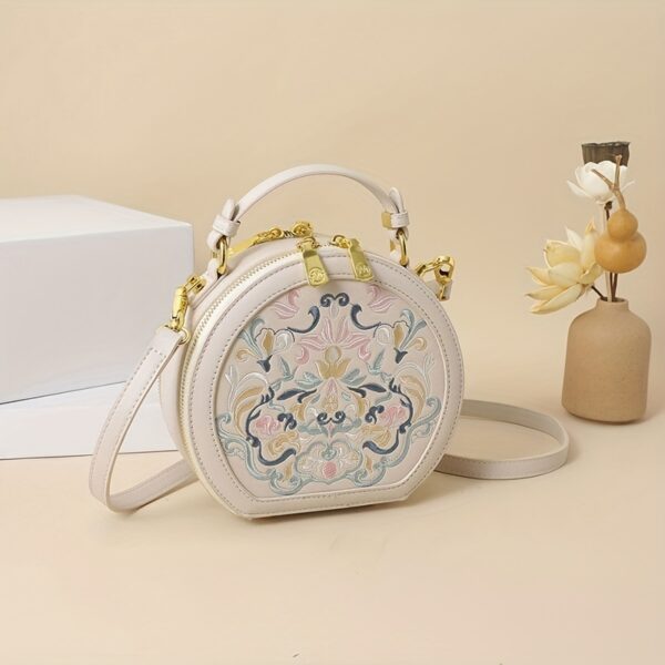 Vienna Embroidered Crossbody Bag in chic faux leather with golden hardware and unique embroidered design.