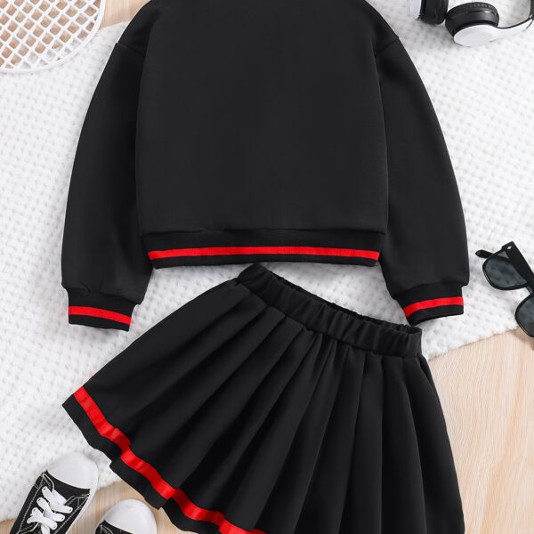 Stylish preppy varsity jacket and skirt set in navy and cream, modeled on a student in a school setting