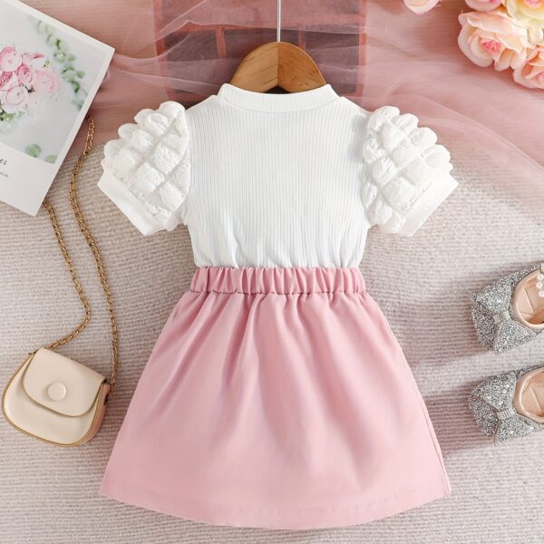Adorable Pastel Dream Girls' Summer Set featuring a pastel-colored top and bottom, perfect for summer. The outfit is shown on a young girl, highlighting its comfortable and stylish design.