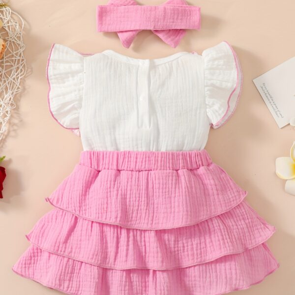 Adorable toddler girl in a vibrant Summer Bloom dress, perfect for summer adventures. The dress features a playful floral print and comfortable, breathable fabric.