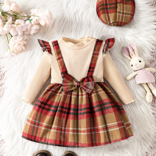 Adorable girl wearing a red and white plaid dress and matching beret. Perfect for spring or fall.