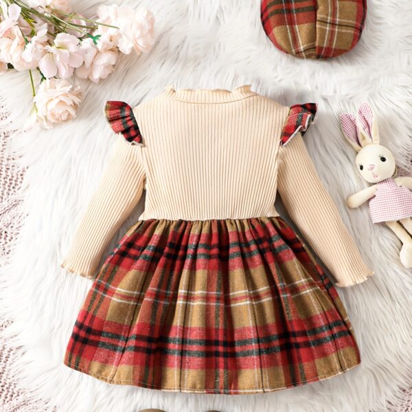 Adorable girl wearing a red and white plaid dress and matching beret. Perfect for spring or fall.