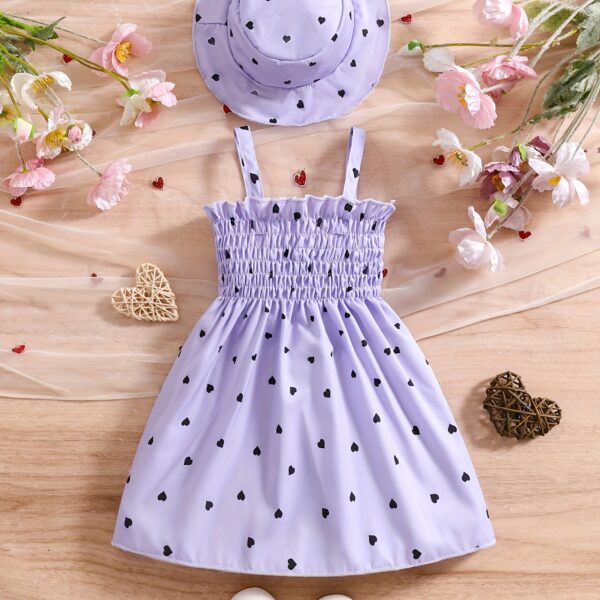 Girl wearing adorable Summer Bloom heart print dress and matching hat set.