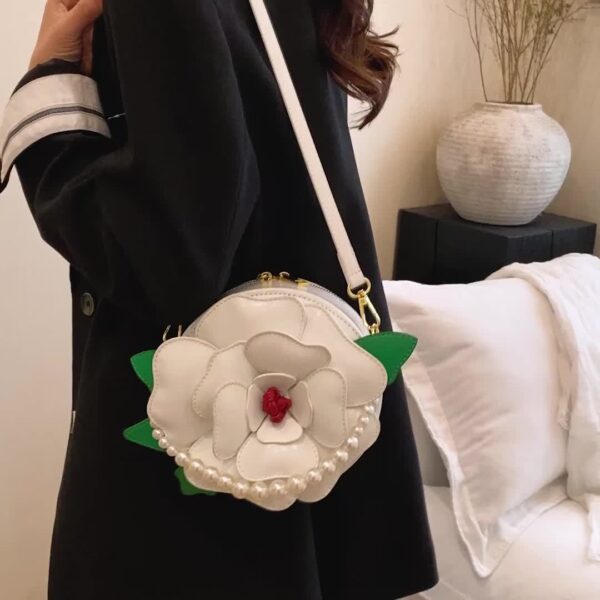 Camellia Blossom Floral Shoulder Bag from Newness, featuring a unique floral design, pearl accents, and an adjustable strap.