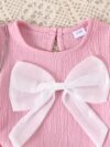 Adorable toddler girl in a stylish summer outfit featuring a cute bow Shop Newness for more childrens fashion