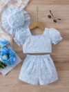 Adorable baby girl wearing a Summer Bloom floral outfit perfect for summer The outfit features a delightful floral pattern