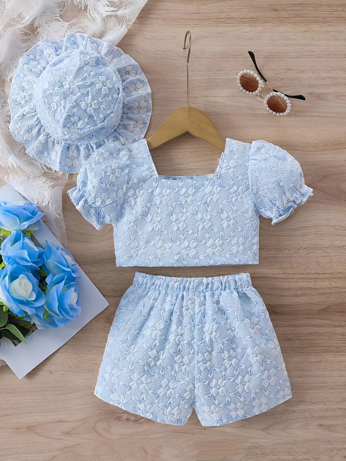 Adorable baby girl wearing a Summer Bloom floral outfit perfect for summer The outfit features a delightful floral pattern